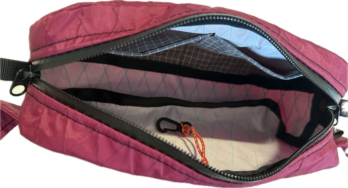 Interior detail of a Towpath Pack in the color port, showing inside pocket and key loop